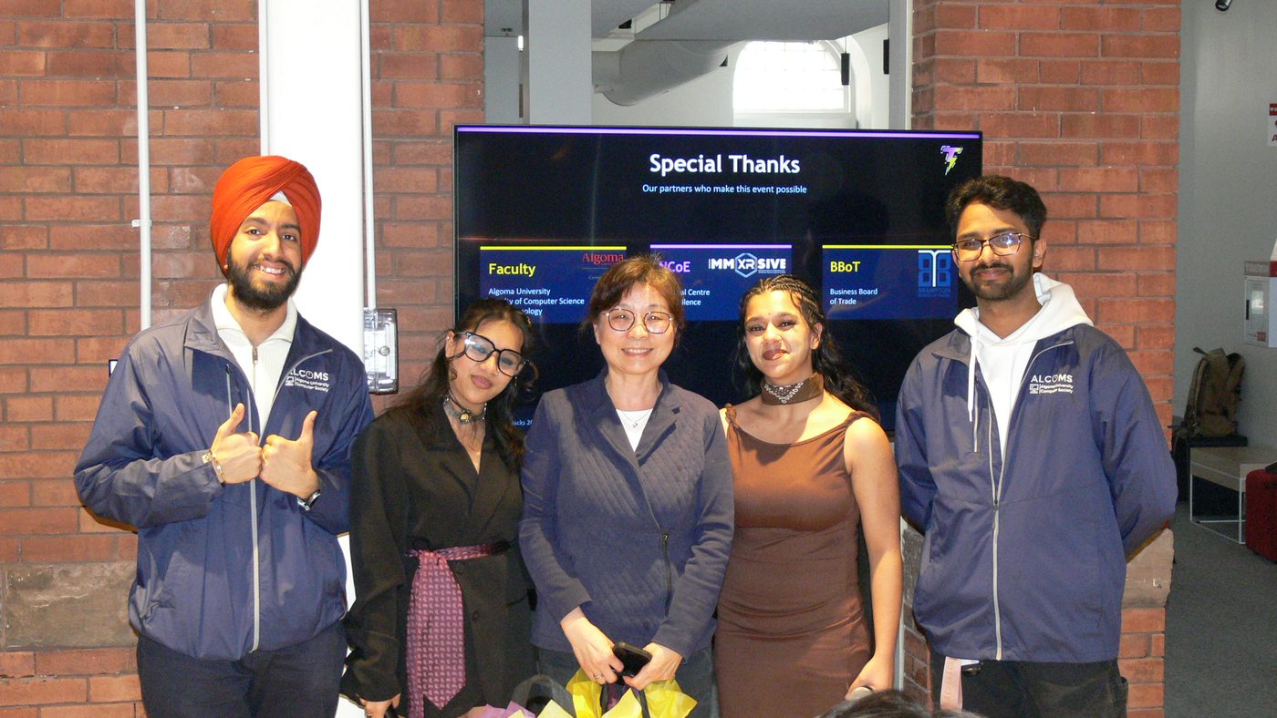 The ALCOMS organising team with faculty in front of the sponsor thank-you screen at ThunderHacks, March 2026